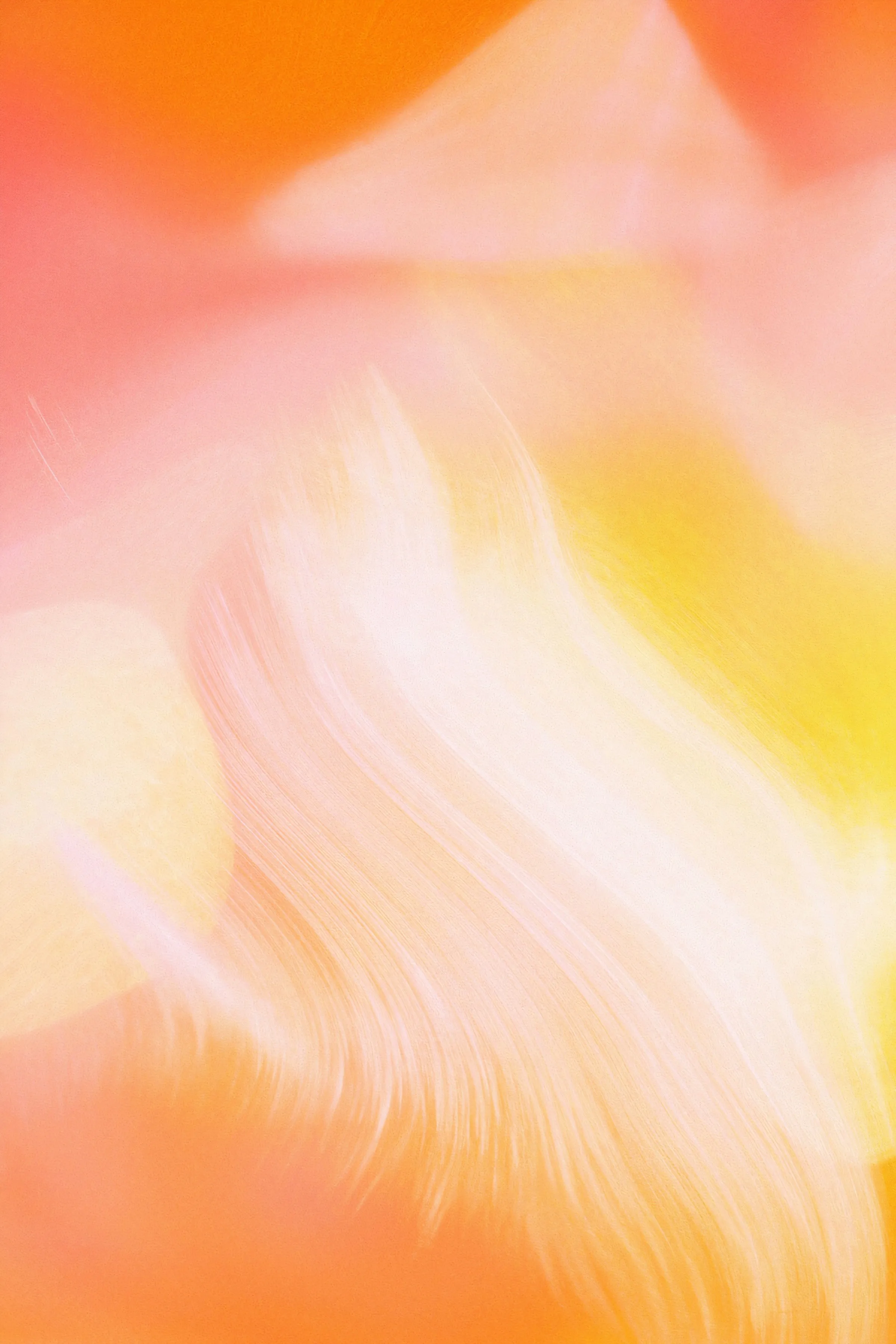 Soft overlapping brushstrokes of orange, pink and yellow light